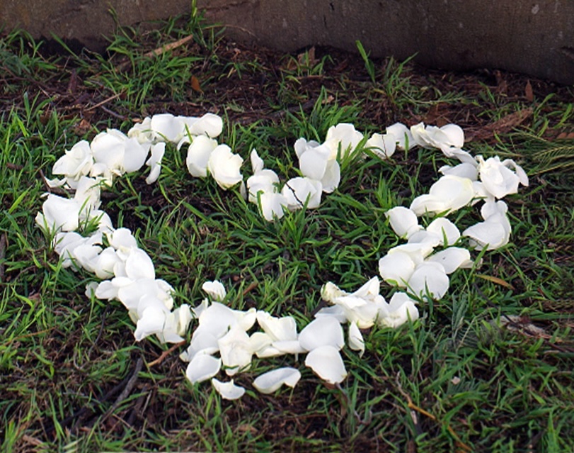 Woman standing in the shower with her face contorted in grief over the death of a loved one