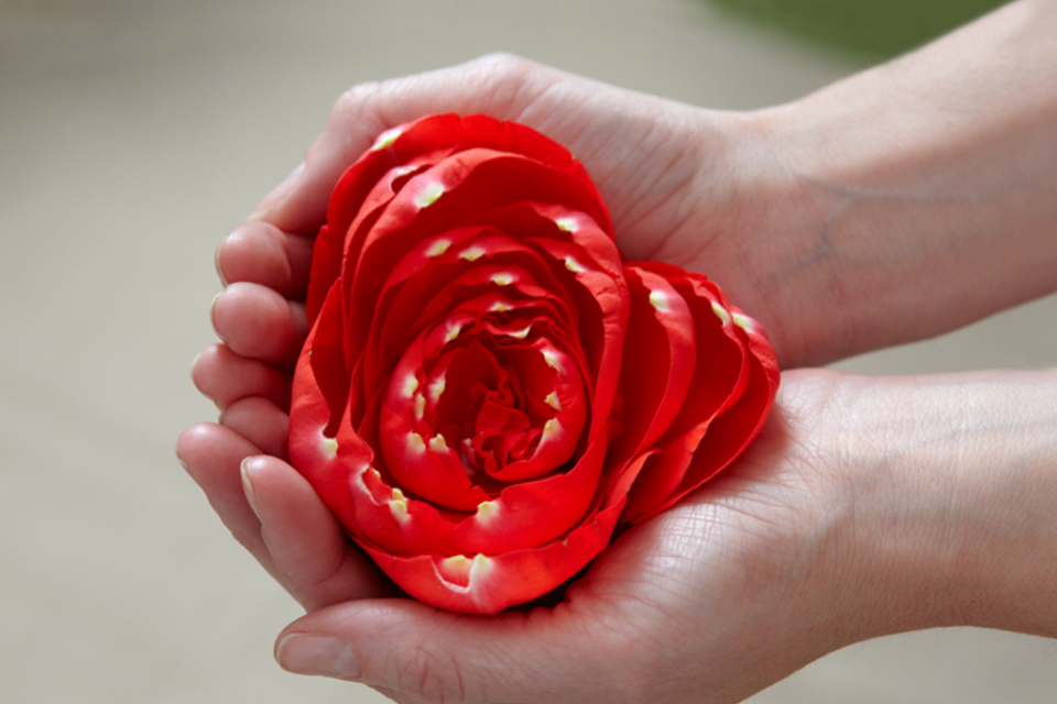Woman standing in the shower with her face contorted in grief over the death of a loved one