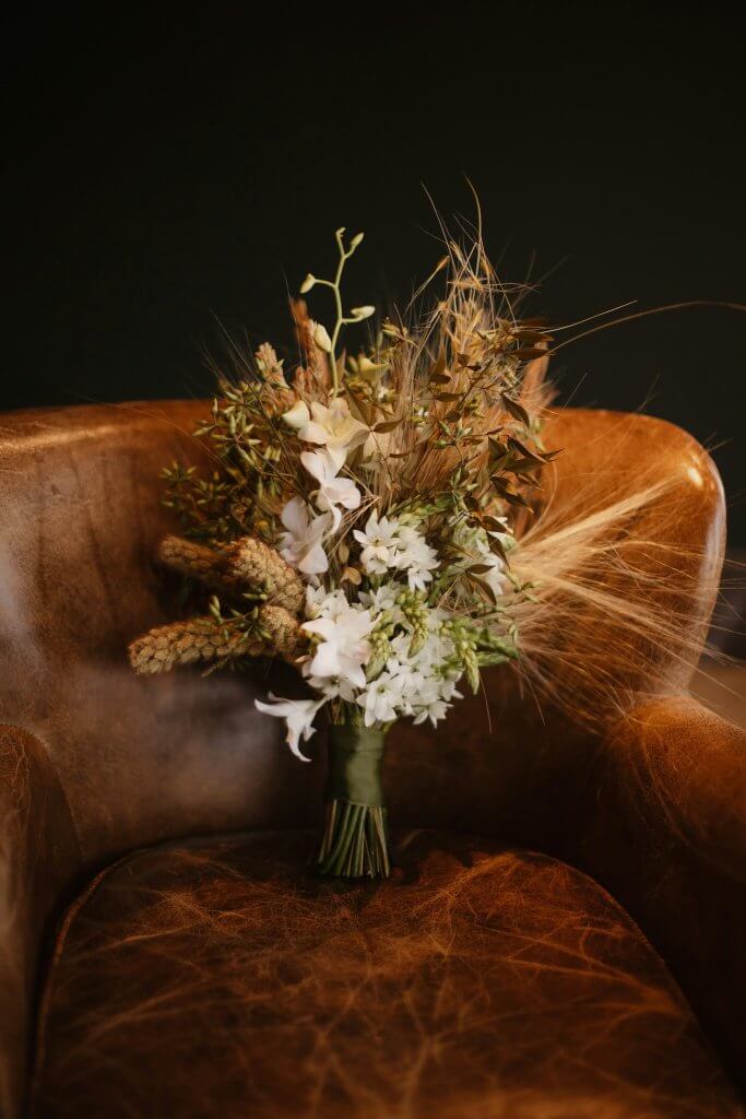 floral arrangement at a celebration of life in the favorite chair of the person honored