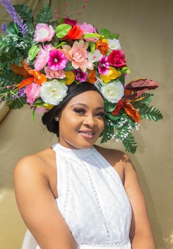 Woman with a floral arrangement on her head at a memorial service