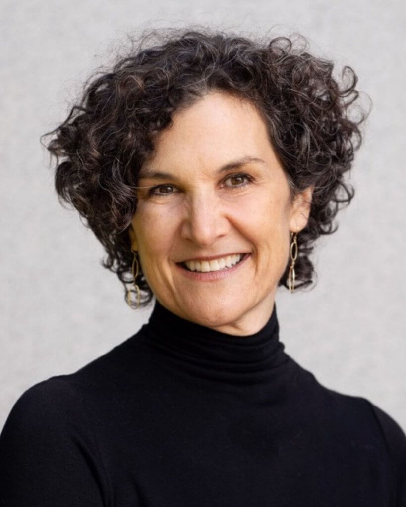 A professional headshot of Jessica Zitter, a middle-aged white woman with close-cropped salt-and-pepper curly hair. 